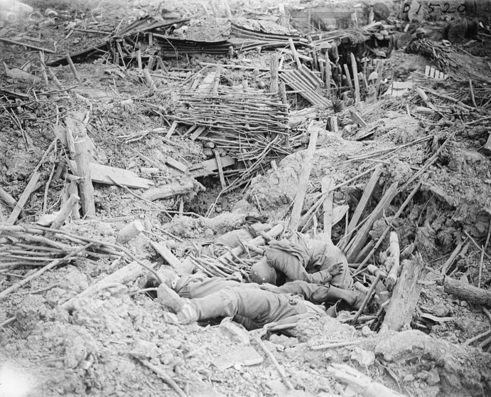 British inspecting a badly damaged German trench on Messines Ridge. Dead German soldiers lie nearby. 7 June 1917.